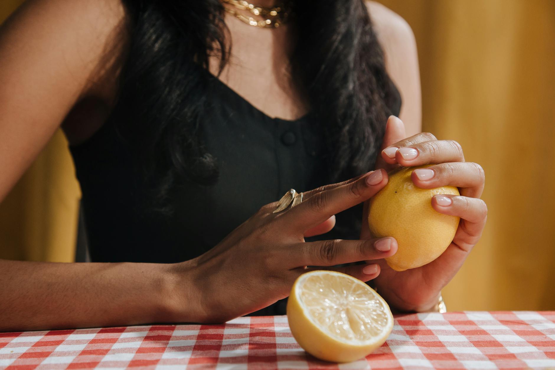 Woman thoughtfully holding blue and pink silicone vibrators, considering pleasure after relationship change